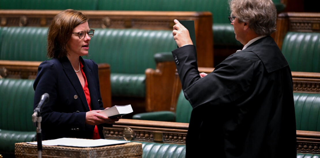 Alex Baker (l) being sworn in as an MP