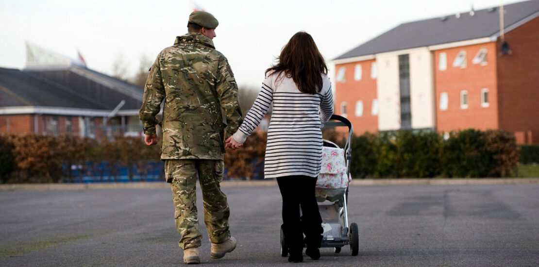 Military couple with a child in a buggy