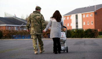 Military couple with a child in a buggy