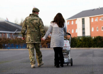 Military couple with a child in a buggy