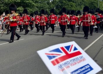 Troops march along Queens Parade at the Armed Forces Day national event 2026